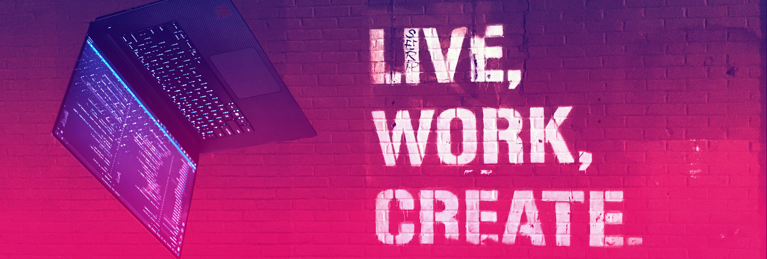 brick wall with 'live, work, create' graffitied on it and an upside down laptop with coding displayed